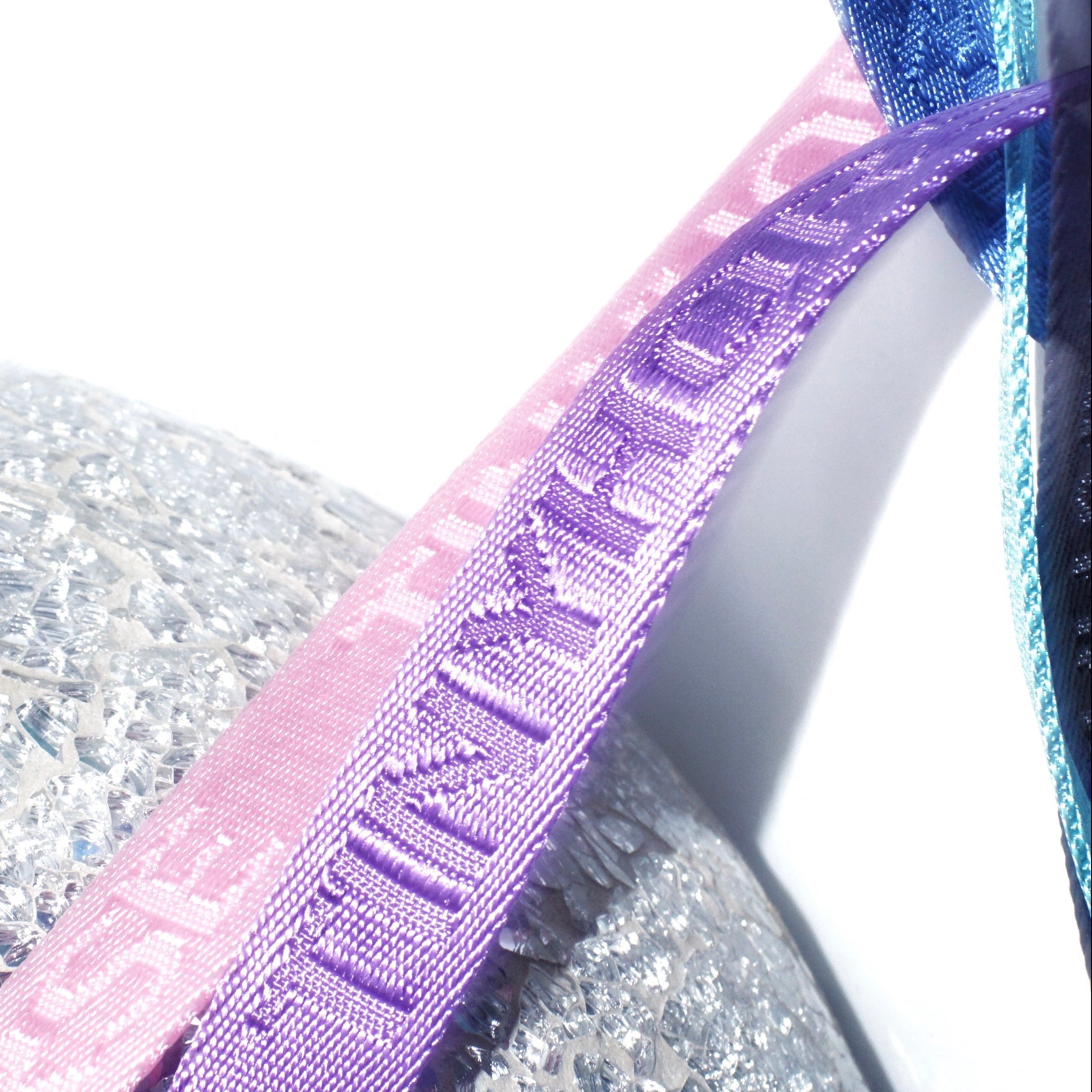 Close-up of purple and blue webbing with TinyHorse logo branded in the weave.