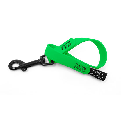 A neon green keeper in bio thane with a black trigger clip on a white background.