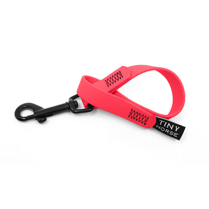 A neon pink keeper in bio thane with a black trigger clip on a white background.