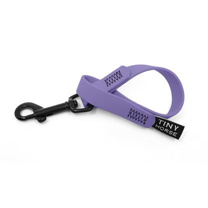 A periwinkle keeper in bio thane with a black trigger clip on a white background.