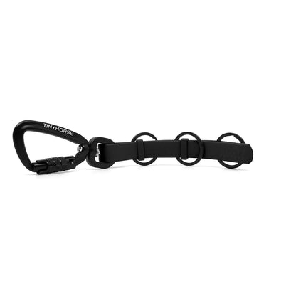 A extra long black key chain with an auto-locking carabiner and three split rings on a white background.
