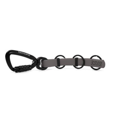 A extra long grey key chain with an auto-locking carabiner and three split rings on a white background.