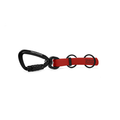 A red key chain with an auto-locking carabiner and two split rings on a white background.