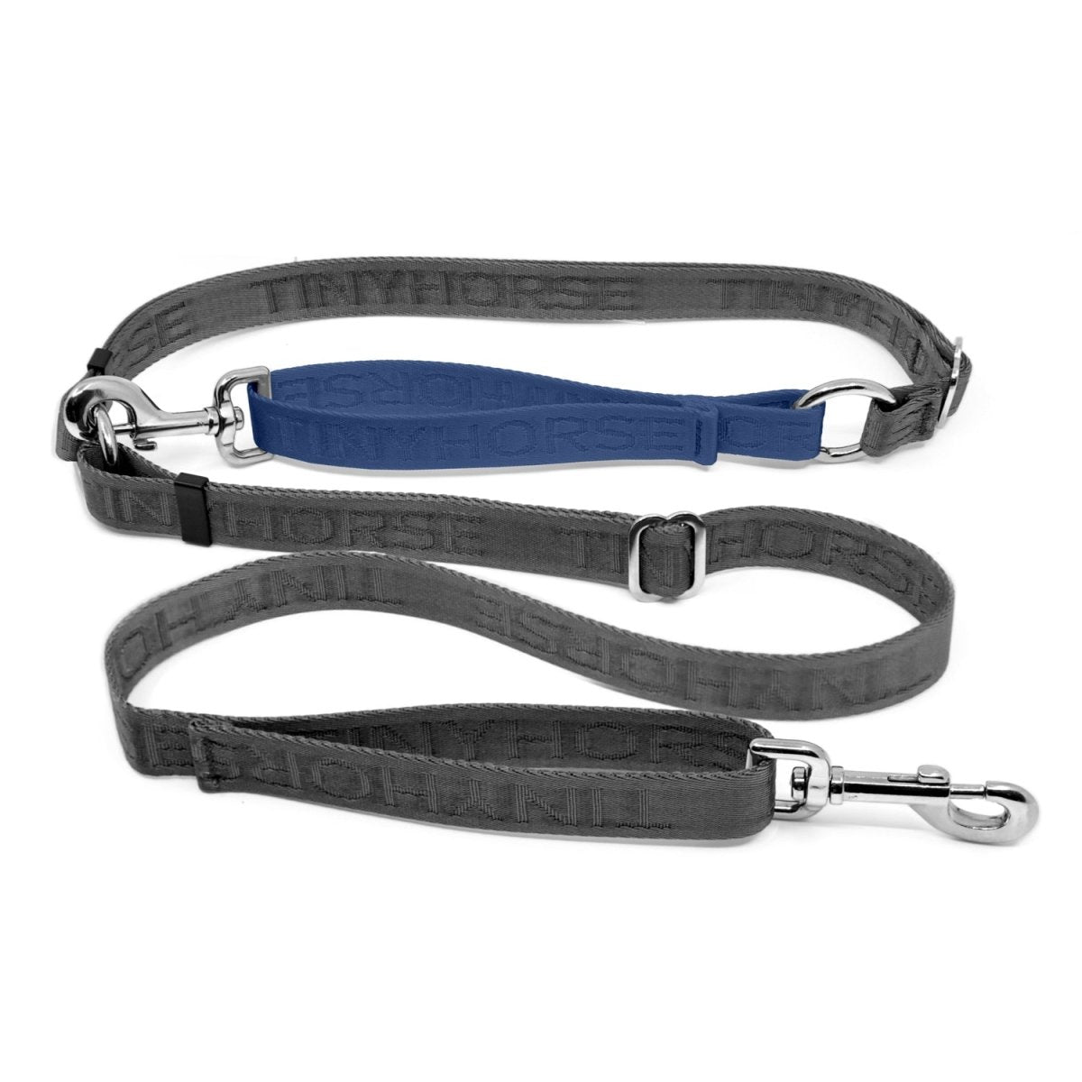 Adjustable hands-free dog leash with traffic handle. Grey with a blue colour accent in front of the hips. Attach more dogs using the rings sewn into the waist. Made of nylon embossed with “Tinyhorse.”