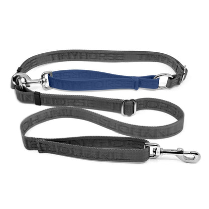 Adjustable hands-free dog leash with traffic handle. Grey with a blue colour accent in front of the hips. Attach more dogs using the rings sewn into the waist. Made of nylon embossed with “Tinyhorse.”