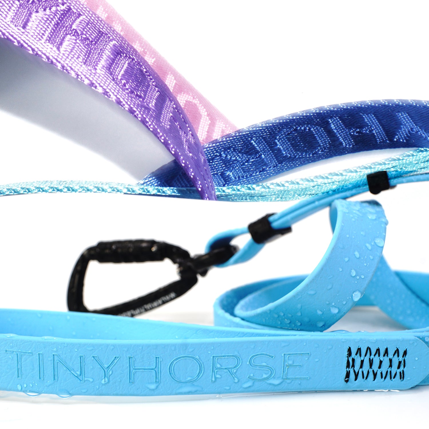 Details of the two different leash materials available: nylon of various colours with a TINYHORSE logo embossed in it, and waterproof Biothane pictured with drops of water on it. The materials are on a white background