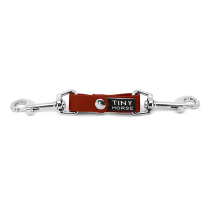 A chilli red security strap on bio thane with two silver triggers on a white background.