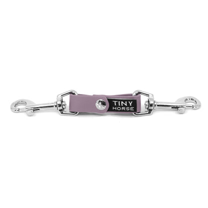 A lavender security strap on bio thane with two silver triggers on a white background.