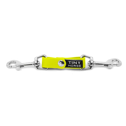 A neon yellow security strap in bio thane with two silver triggers on a white background.