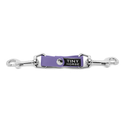 A periwinkle security strap on bio thane with two silver triggers on a white background.