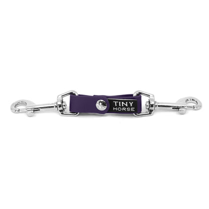 A purple security strap on bio thane with two silver triggers on a white background.